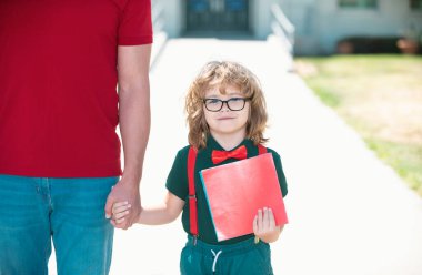 İnek çocuk. Okul, aile, eğitim ve açık hava konsepti. Çocuğun ailesi sırt çantasıyla dışarı çıktı ve okula döndü.