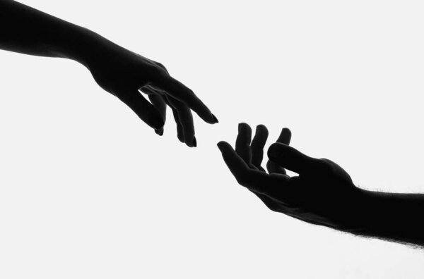 Reaching touching hands. Reach hand. Hopeful concept. Two hands trying to touch. Adam sign. Human relation, togetherness. Hands of man and woman reaching to each other. Hand try to touch