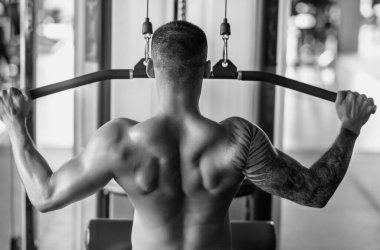 Portrait of handsome sporty man with muscular body doing weight lifting. Guy workout at gym. Fitness trainer, sport instructor, sporty man, fit model, sportsman workout. Power athletic guy bodybuilder