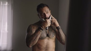 Beautiful portrait of man shave using shaving foam for better perfect shave. Concept: barber, shaving cream and man. Beauty Men