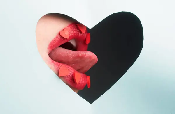 stock image Beauty lovely lips. Lip with hearts through paper. Hearts makeup. Love concept. Lipscare