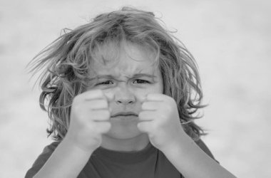 Child temper with angry expression. Angry hateful little anger boy, child furious. Angry rage kids face close up. Anger hateful child with furious emotion portrait. Aggressive and mad kid behavior clipart