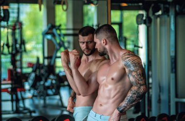 Man exercising with dumbbell. Male bodybuilder doing weight lifting workout at gym. Training with barbell. Muscled man strong muscular fit man workout with heavy weight. Exercises for muscular body