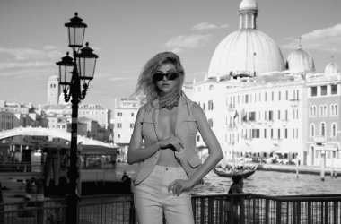 İtalya, Venedik 'te yürüyen çekici genç bir kadın. İtalyan yaz tatili. Venedik caddesindeki moda kadını. Venedik 'te yaz tatiline çıkan gezgin kadın.