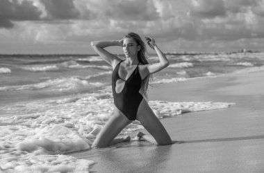 Woman in bikini on the tropical beach. Summer portrait of young beautiful girl on beach with bikini. Beautiful young woman on the beach. Freedom and carefree concept