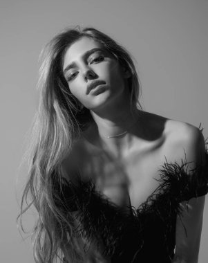 Seductive sexy lovely attractive young sensual woman in fashion black dress and perfect slim body posing on gray studio background. Beautiful elegant fashion model, studio portrait. Beautiful face