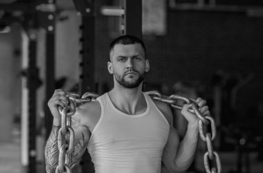 Muscular athletic fit man hard workout fitness in gym. Sport fitness and bodybuilding. Strong muscular doing exercise in the gym. Sexy muscular male body. Fitness man in the gym. Fitness training