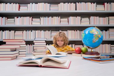 School and students in classroom. Education kids. Child pupil student in the school class. Studying and learning concept. School boy in the library near school supplies. Kid learn geography with globe