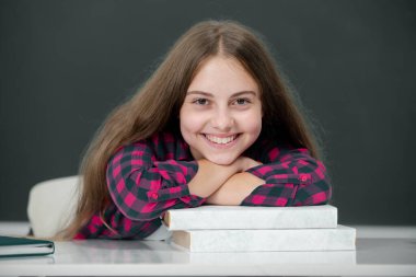 Back to school. Happy School and students in classroom. Education kids. Smiling Child pupil student in the school class. Studying and learning concept. Portrait of schoolgirl on the blackboard