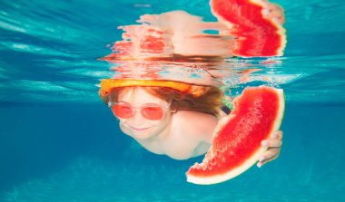 Summer watermelon. Funny kids boy play and swim in the sea water. Child swimming underwater in swimming pool. Summer travelling