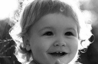 Portrait of a happy laughing child. Close up positive kids cropped face. Baby smiling, cute smile