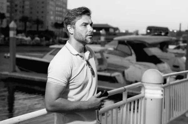 stock image Stylish man wearing sunglasses and shirt. Handsome man outdoors portrait. Portrait of stylish male model outdoor. Fashion male posing near skyscraper on the street. Fashionable man in urban style