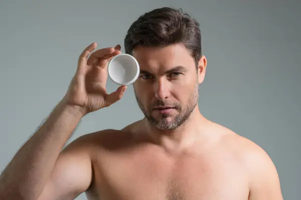 stock image Beauty male face cream. Beauty routine. Beauty man with perfect skin. Anti-aging and wrinkle cream. Concept of male beauty. Close-up face of man applying cream to skin. Skincare cosmetics concept