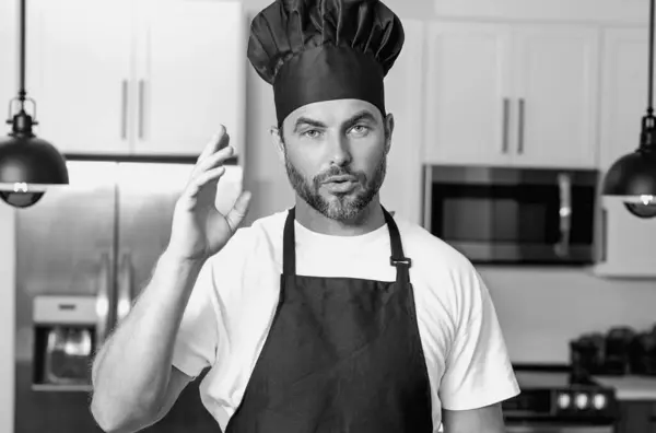 Stock image Handsome middle age man in chef uniform at kitchen. Cooking and culinary. Restaurant menu concept. Catering and cooking, advertising food concept. Man chef in uniform in kitchen