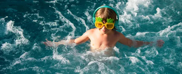 stock image Boy swimming and playing in a pool