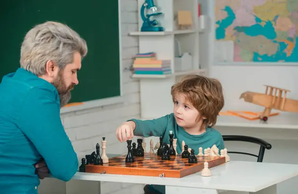 stock image Chess success and winning. Family relationship with son. Cute boy developing chess strategy. Concept of education and teaching. Educational games