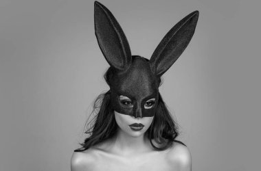 Lovely, romantic sexy woman in rabbit ears celebrating easter holiday, studio background. Holidays, spring and party concept. Sensual girl celebrating Easter in rabbit ears
