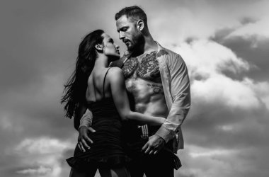 Naked shirtless muscular man and sexy woman. Loving people. Beauty woman gently undressing sexy body of sexy lover. Lovely couple in love. Sexy girl and fit muscular boyfriend with naked bare torso