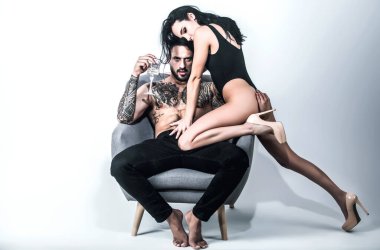 Naked shirtless muscular man and sexy woman. Loving people. Beauty woman gently undressing sexy body of sexy lover. Lovely couple in love. Sexy girl and fit muscular boyfriend with naked bare torso