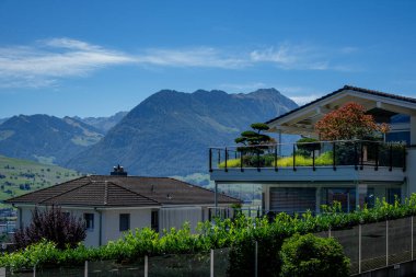 Doğanın modern dış görünüşü. İsviçre 'de modern ev cephesi. Yaşamak için ideal tasarım. Alps Dağı yakınlarında modern tarz bir ev. Alpler 'deki dağ manzaralı modern ev.