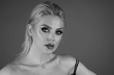 Eyes make up, red lipstick on plump lips. Portrait of beautiful young woman with hairstyle. Closeup photo of amazing hairdo lady, isolated studio background. Portrait of caucasian female model