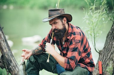 Balıkçılık hobisi ve yaz tatili. Sakallı adam olta kamışlı balıkçı