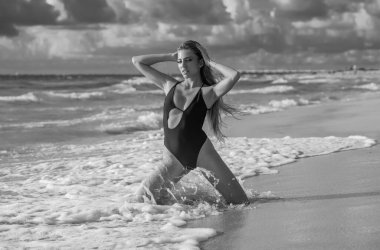 Sexy tanned girl in bikini swimsuit on sea background. Fashion woman in bikini relax on beach. Happy summer lifestyle. Sea of tropical beach. Vacation at Paradise