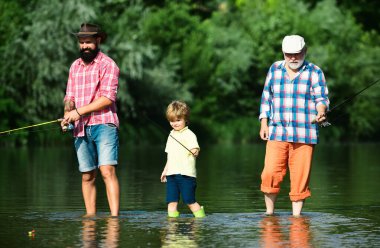 Boy with father and grandfather fly fishing outdoor over river background. Fishing became a popular recreational activity clipart