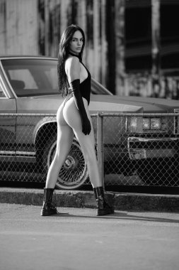 Sexy Back, Ass. Woman Posing Sexy Outdoor near Garage Wall. Beautiful Slim Woman Body. Firm Buttocks. Perfect Female Booty Body. Sexy Shape of Buttocks. Sensual Portrait of a Beautiful Sensual Woman