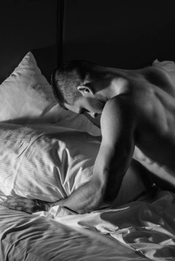 Mans naked body, muscular shoulders. Naked man in bed. Muscular sexy male bum. Gay sexy model. Muscular sexy man with naked torso. Hunk with athletic body. Carefree guy enjoying night