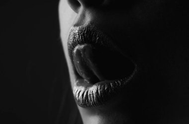 Dil yalayan dudaklar. Şehvetli kadın ağzı. Seksi kız altın dudaklar, altın ağız. Parlak altın ten ve yaldızlı dudaklar. Metalik parlak altın dudak parlatıcısı