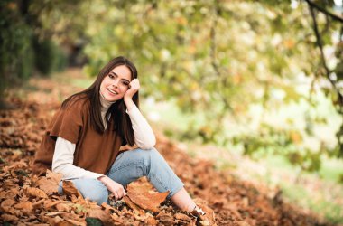 Sonbahar yapraklı genç bir kadının portresi. Romantik kız rüyası, sonbahar akçaağaç yapraklarını tut. Sonbahar mevsimi