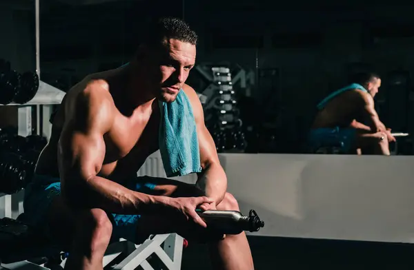 stock image Shirtless sportsman resting after training at the gym. Fitness sports concept