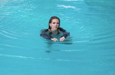 Sexy woman relaxing in swimming pool on summer vacation. Sexy sensual model in bikini. Resting, leisure and recreation, summer fun. Fashion woman in swimming pool. Glamour girl in luxury pool