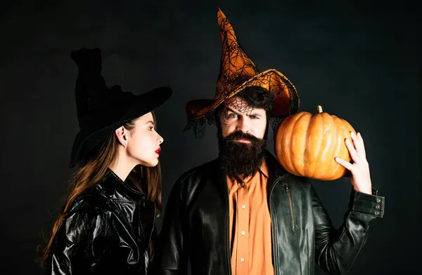 Stock image Beauty Halloween girl and Handsome bearded man hold pumpkin on black isolated background