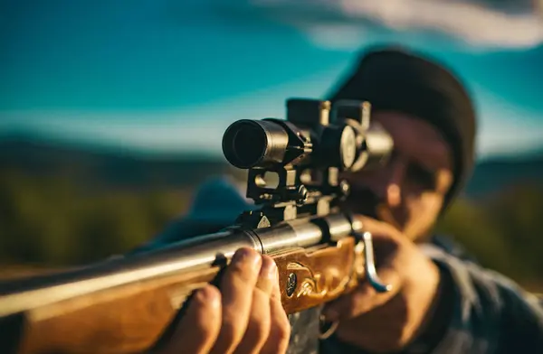 stock image Close up snipers carbine at the outdoor hunting. Hunter aiming rifle in forest. Hunter with shotgun gun on hunt. Hunter with Powerful Rifle with Scope Spotting Animals