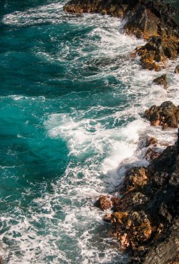 Dalgalar kayalara çarpıyor. Denizde kayalıklar, deniz manzarası