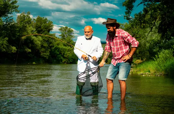 Erkeklerin hobisi ve eğlencesi. Balıkçılar başarılı bir şekilde balık yakalar. Fisher emekliliği. Balıkçı oltasıyla takım elbiseli emekli bir işadamı. Erkek arkadaşlığı. Dedem ve Drandson balık tutuyor.
