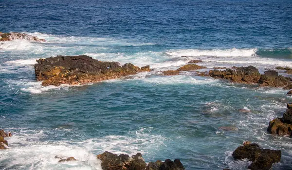 stock image Sea background. Ocean wave crashing on rock coast with spray and foam before storm