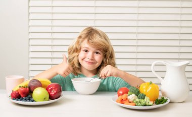 Morning snack with muesli cereal granola. Little child boy having healthy breakfast. Kids nutrition and development. Eating vegetables by child make them healthier