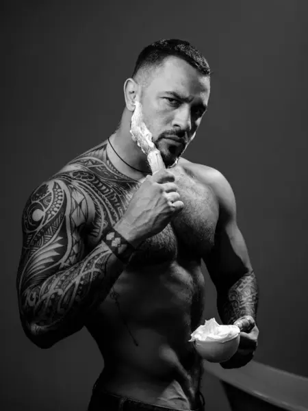 Stock image Shaving man with foam cream on face. Handsome sexy man shaving