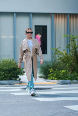 Trendy coat. High fashion model walking on street. Woman fashion style. Fashion beautiful elegant woman. Beautiful woman wearing fashionable clothes. Girl vogue style. Fashion shot