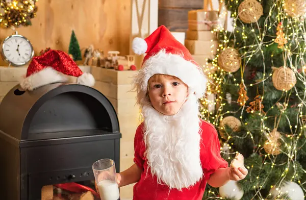 stock image Milk and gingerbread cookie for Santa against Christmas light bokeh background. Kid Santa Claus takes a cookie on Christmas Eve as a thank you gift for leaving presents to a grateful boy or girl