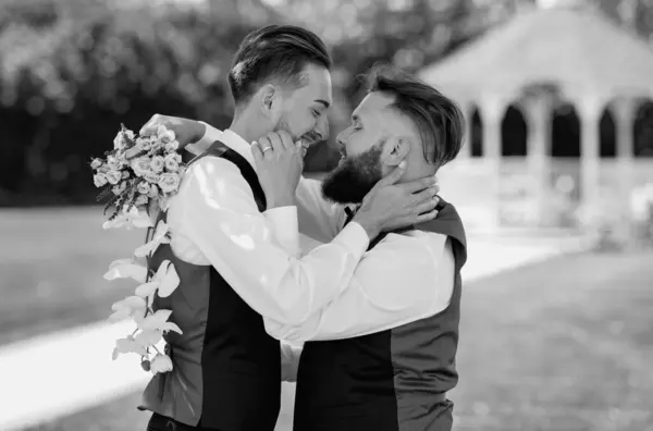 stock image Gay with partner with care and love. Gay couple holding bouquet of flower together during wedding ceremony. Homosexual couple celebrating their wedding. LBGT couple at wedding ceremony