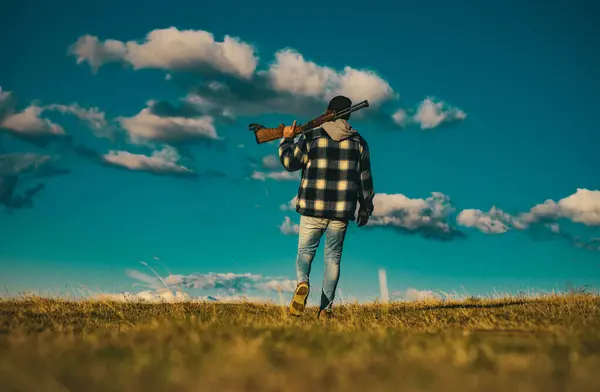 stock image Hunter with shotgun gun on hunt. Illegal Hunting Poacher in the Forest. Hunting is the practice of killing or trapping animals