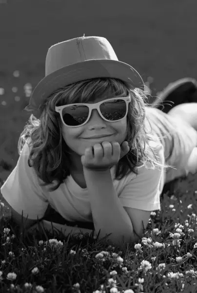 stock image Kid summer. Happy child enjoying on grass field and dreaming. Summer dream. Kid dreams on grass. Childhood dream. Daydreamer child. Dreams and imagination. Dreamy kids face