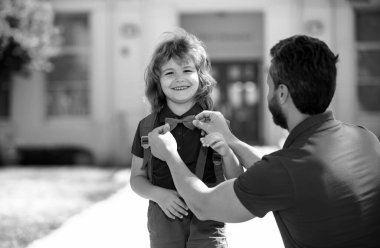 Parent taking child to primary school. Portrait of little happy nerd toddler boy ready for school. School education, study grade, little student back to school concept clipart