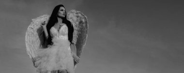 Banner. Valentines day. Woman with angel wings. Portrait of angel girl on sky background with copy space