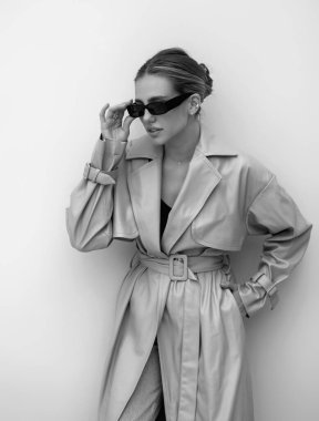 Trendy coat. High fashion model walking on city street. Girl fashion style. Fashion beautiful elegant woman. Young woman wearing fashionable clothes. Girl vogue style. Fashion shot