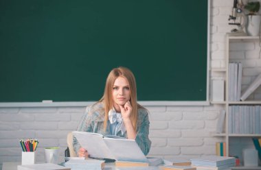 High school student learning english, reading book or mathematics in class